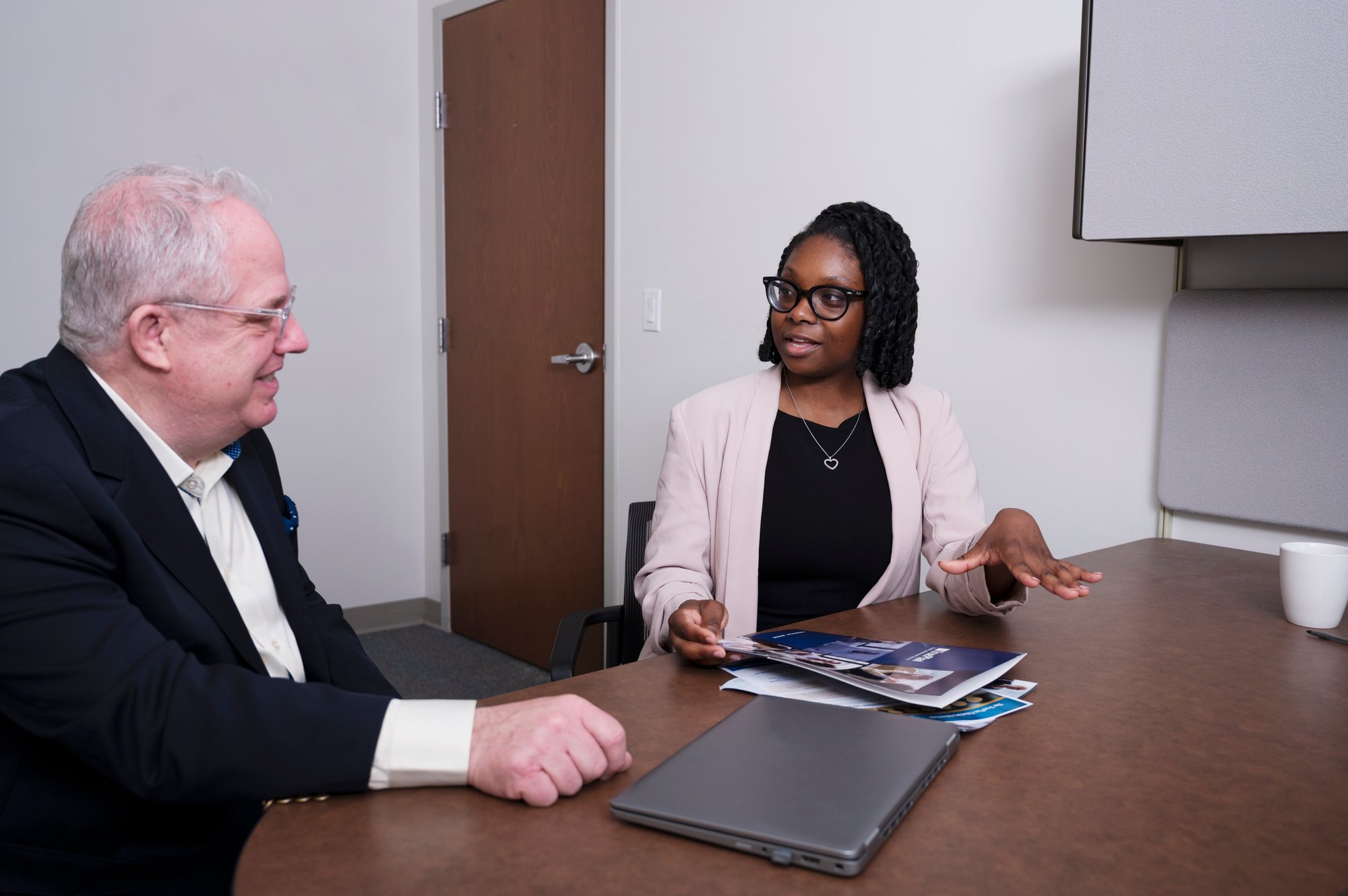 Bernard Gleeson and Regine Russell discussing benefit plan operation