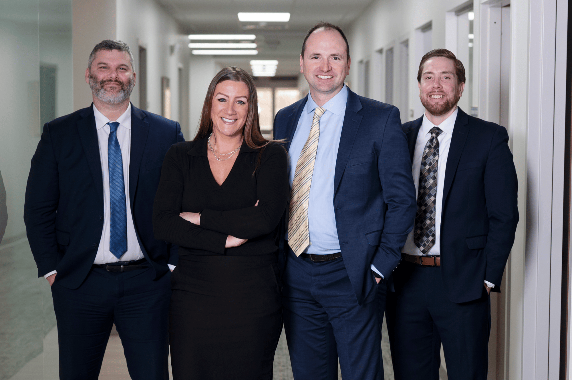 Team of TruePlan Benefit and Retirement Advisors posing together in a hallway