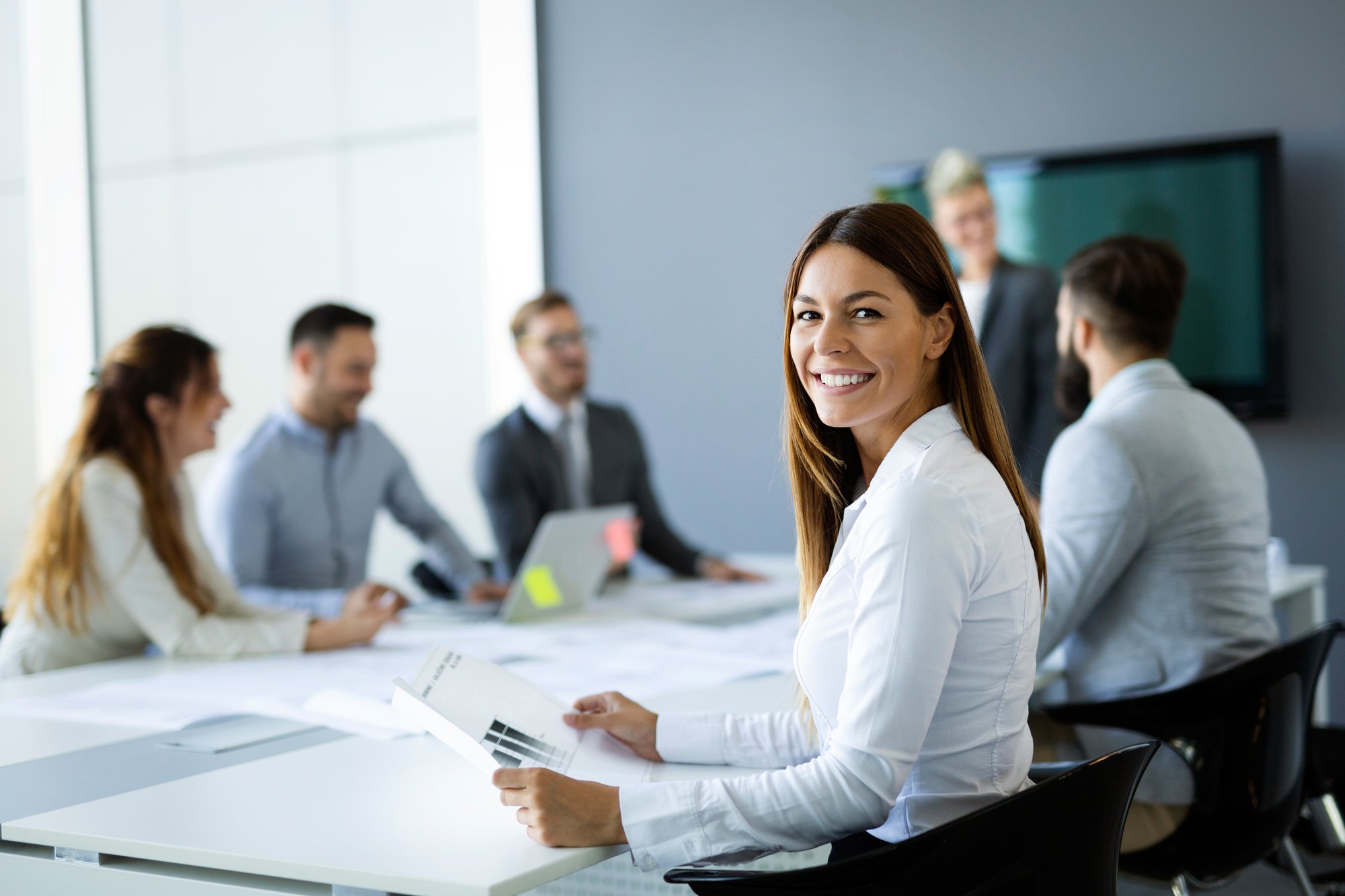 Advisor smiling while team talks about proven strategies