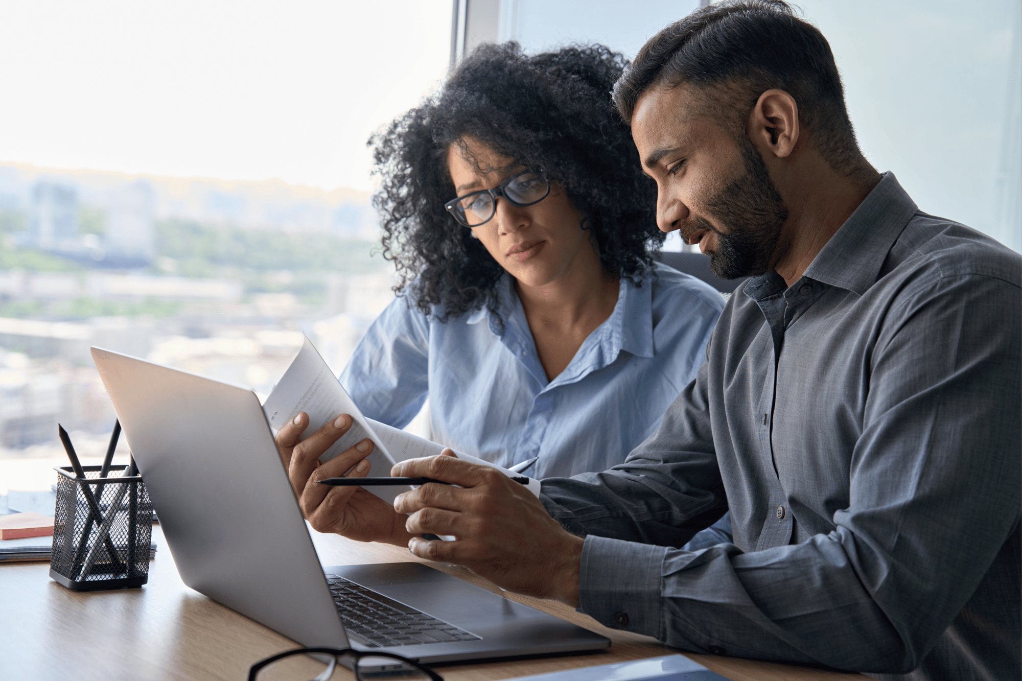 Two people reviewing employee benefits recommendations